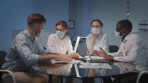 Interracial Business Team in Safety Mask Brainstorm Idea at Office Meeting Room alt