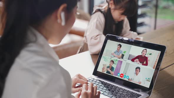 Group of Asian business mom talking to colleague team about plan in video conference with daughter. alt
