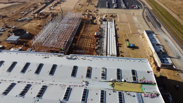 Aerial Drone Flight Over a New Constructions Development Site Warehouses Projects and Heavy alt