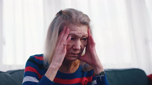 Old Woman Having a Headache alt