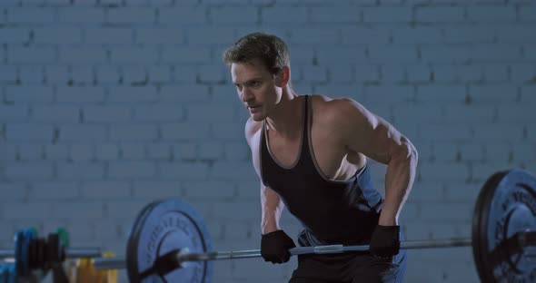 Deadlift is Done By a Professional Athlete on a Training in a Modern Gym a Dark Gym alt