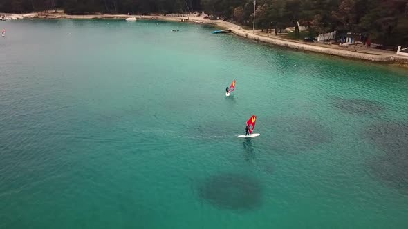 Aerial view of man practicing kitesurfing at transparent water, Croatia. alt