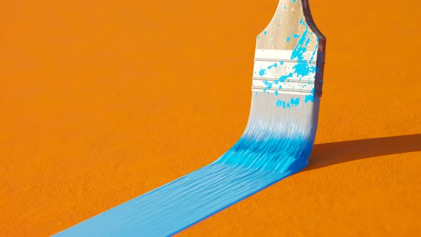 Wooden paintbrush leaving stripe of colorful cyan paint on an orange wall. 4KHD alt
