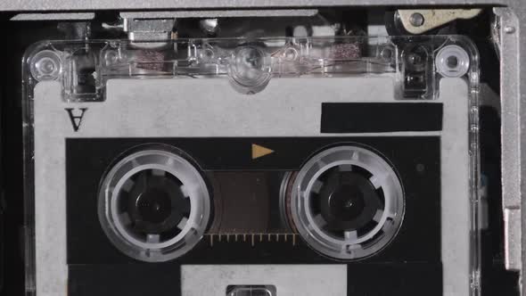 The Microcassette Spins in a Portable Handheld Recorder Tape Retro Player alt