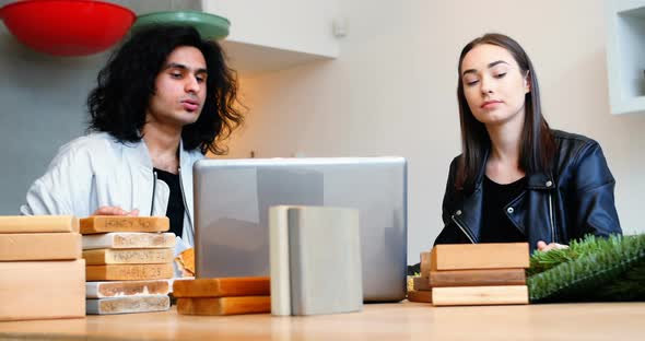 Executive using laptop while having breakfast alt
