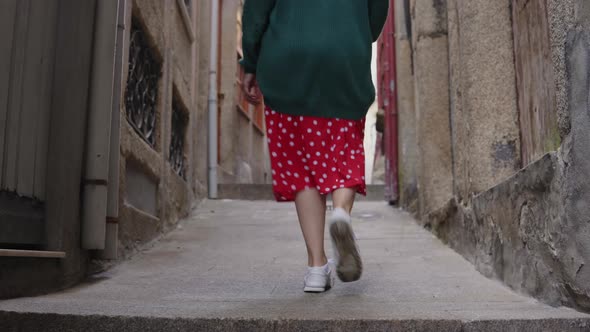 Woman Tourist Is Walking and Taking Photos in Old City alt