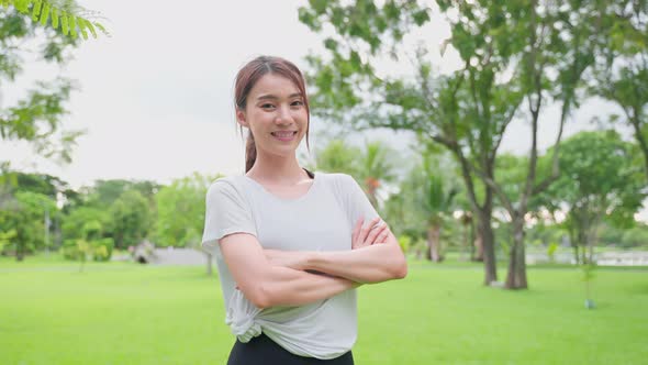 Portrait of Asian active sport woman stand with confidence after exercise outdoors at public park. alt