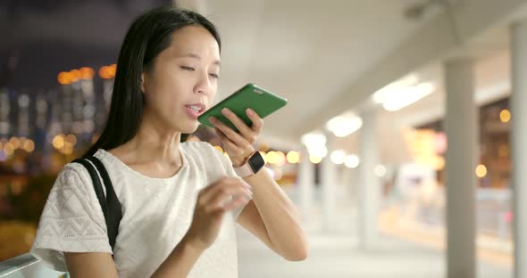 Woman use of smart phone in Hong Kong at night alt