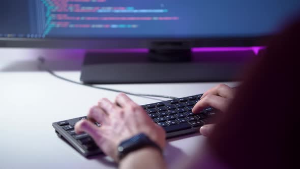 Macro View of Mans Hands Who is Typing on Keyboard and Coding a Program on a Computer alt