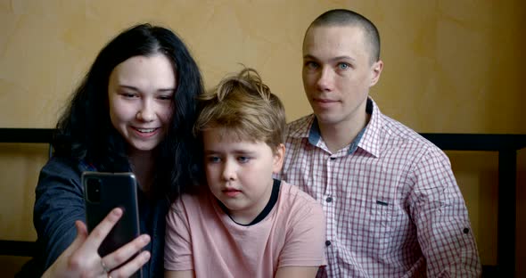 Family Is Communicating By Video Call Through Smartphone with Friends, Stay at Home alt