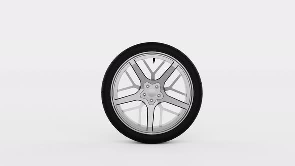 Seamless looping of rubber wheel spins across the screen back and forth on isolated white background