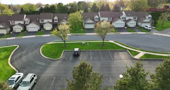 American townhouse homes in springtime season. Spring golden hour sunset. Aerial view. alt