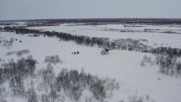 A Large Passenger Helicopter Landed on the Tundra in the Arctic for People