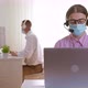 Colleagues work in the office using laptops in protective masks. - VideoHive Item for Sale