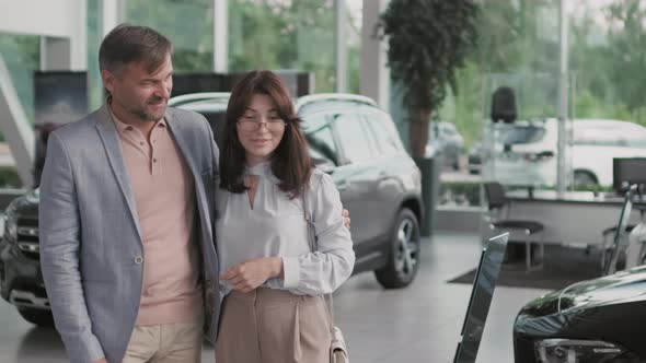 Slowmo of Couple in Car Dealership alt