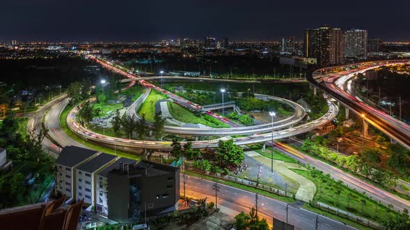 Highway interchange junction in Bangkok outskirt, at night; zoom in - time lapse