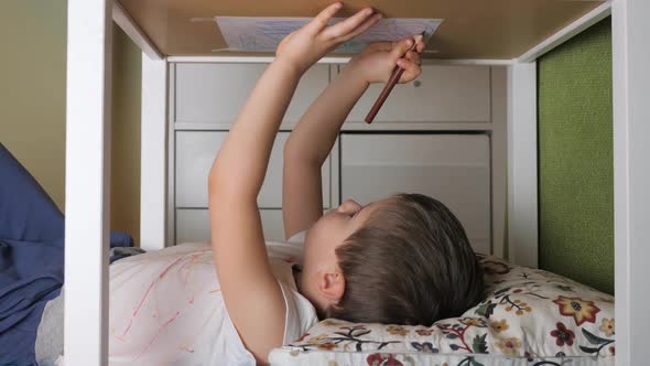 Boy Painting Upside Down. Stayathome. Leisure Activity at Home, Indoor. Preschooler Drawing Lying alt