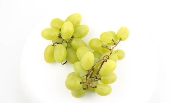 Ripe Juicy Grapes Rotate on a Plate