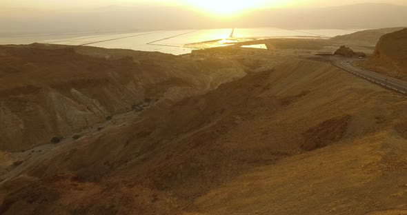 Sunrise Through the Desert Mountains by The Dead Sea