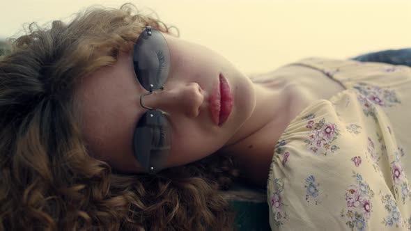 Closeup Girl Opening Eyes Wearing Sunglasses on Nature alt