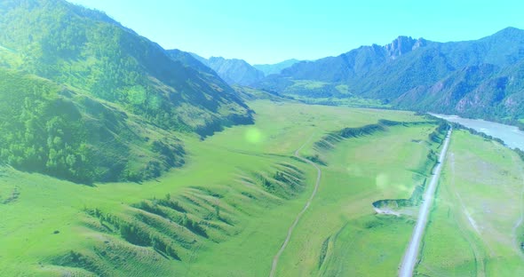 Aerial Rural Mountain Road and Meadow at Sunny Summer Morning alt