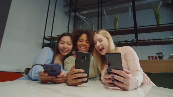 Carefree Multiethnic Females Taking Selfie Shot in Coffee Shop alt
