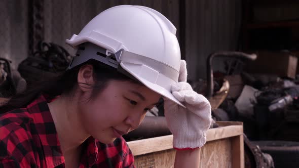 Depressed Asian Female worker or engineer portrait. alt