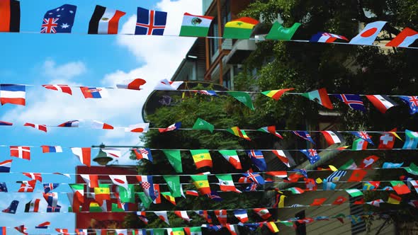 Fluttering flags of all states on the streets of the city, the unity of nations alt