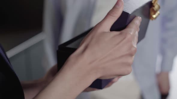 Young Male Hand Opening Gift Close-up. Unrecognizable Caucasian Guy Receiving Present for alt