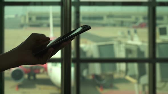 Typing Text Message On Smartphone At Airport alt