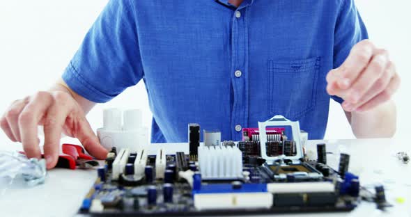 Computer engineer repairing computer motherboard alt