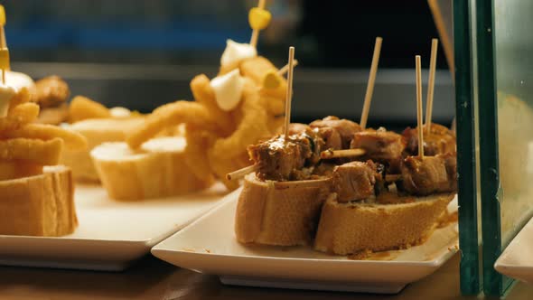 Showcase Window Display Assortiment with Tapas – Traditional Spanish Sandwiches Starters in a Cafe alt