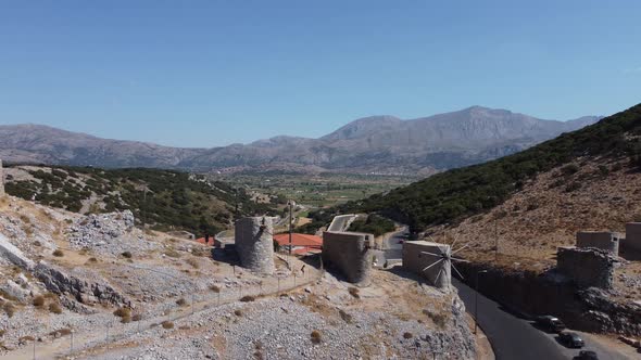 Mills in Motion on Mountain Peak By Mediterranean Sea Crete Greece
