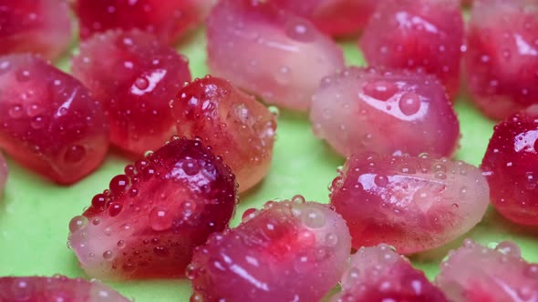 Macro Shot of Water Drops on Ripe Red Pomegranate Fruits