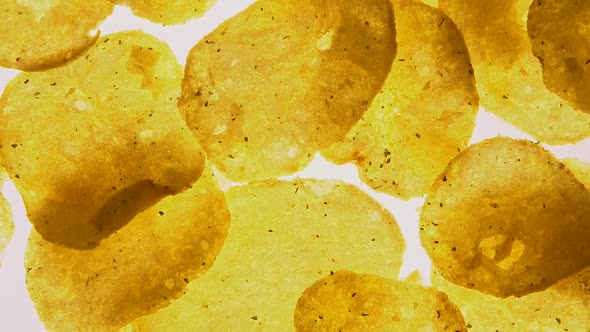 Spicy Potato Chips Spinning on White Background, Food With Flavor Intensifiers alt