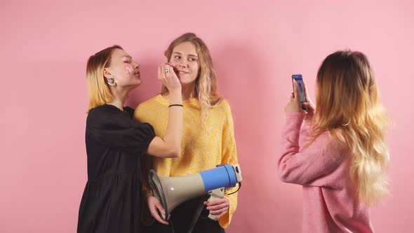 Three Young Women in Blouses Are Going To Fight for Women's Rights, Isolated in the Studio alt