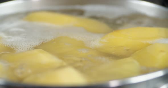 Potatoes Cooked in Water in a Pot with Air Bubbles.  alt