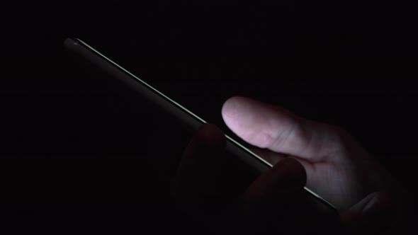 Reflection of screen on person's blue green eye in dark room 13 alt