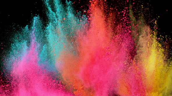 Super Slowmotion Shot of Color Powder Explosions Isolated on Black Background alt
