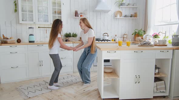 Caucasian Adult Active Mother Babysitter with Long Hair and Teenager Girl Daughter Child in Jeans alt