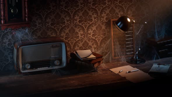 Old dark room with vintage desk and chair.  Cobwebs on radio, books and abacus. alt