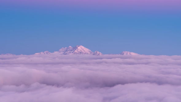 Foggy Sunset in The Mountains with Pink Alpine Glow and Mist alt