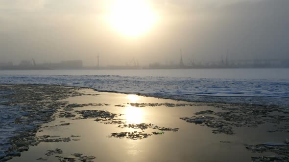 View At The Frozen Bay With Winter Sun And City Silhouette, Winter Landscape