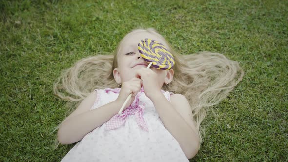 Blond girl on green grass