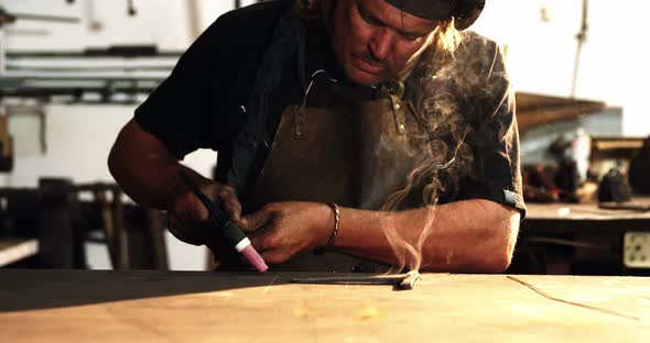 Welder using welding torch alt