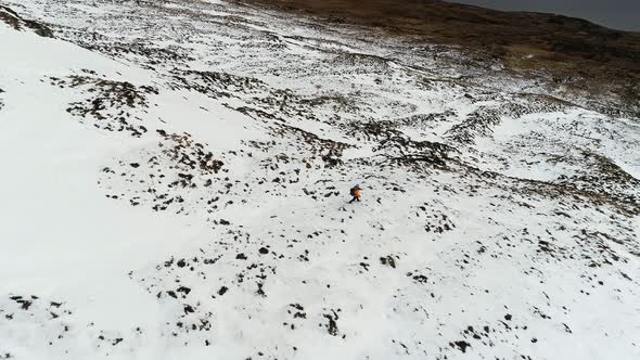 Mountaineer Walking Through Snowy Environment alt