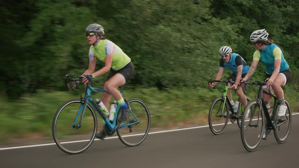 Tracking shot of a group of cyclists on country road.  Fully released for commercial use.