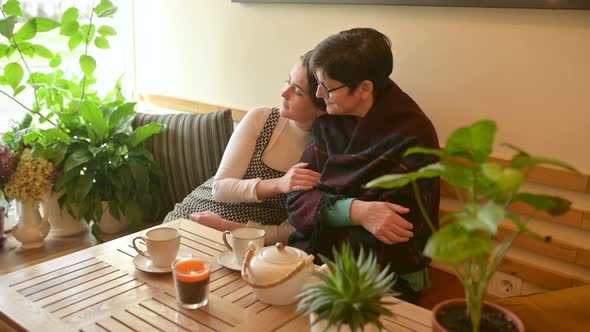 Happy family middle aged old mother and young adult daughter communicate and hug alt