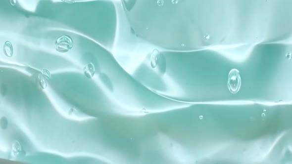 Beige Yellow Transparent Cosmetic Gel Fluid With Molecule Bubbles Flowing On The Plain Surface alt