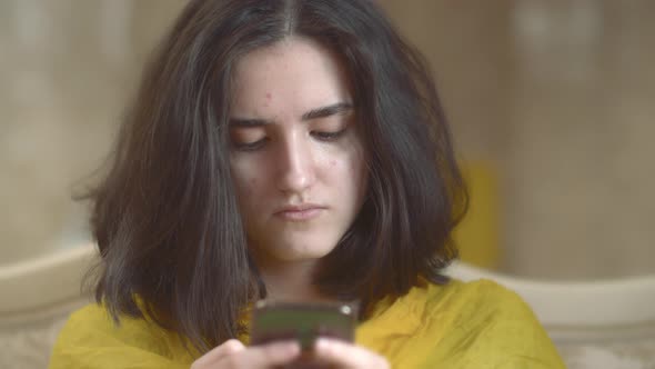 Portrait of Young Brunette Teenager with Mobile Phone Closeup alt